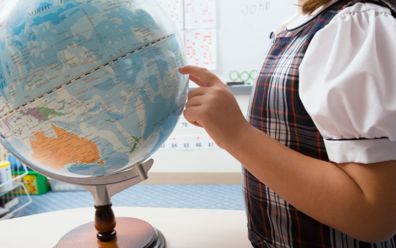Little Girl Looking At A Globe, Pointing Out To A Country In The Homeschool, You Can Blend Music With Any Subject In The Homeschool, And Geography Is One Such Subject