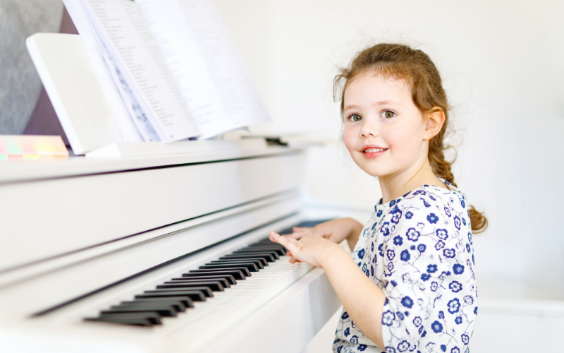 Little Girl Practicing On A White Grand Piano, Know How You Can Have Your Kids Begging For Piano Practice