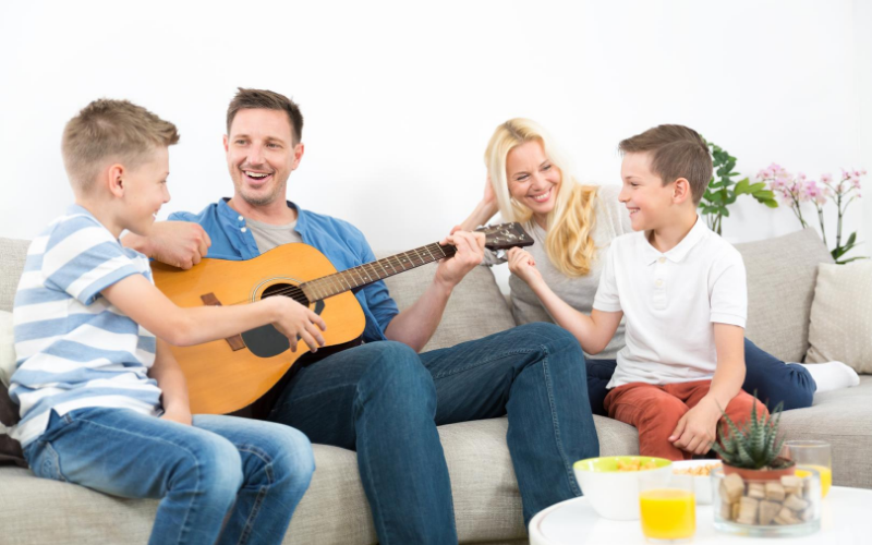Mother, Father, Sons In The Homeschool Learning Music